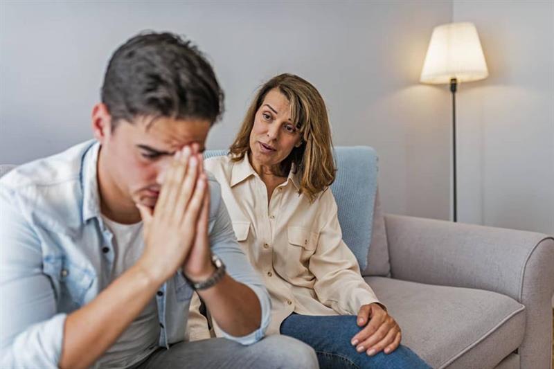 A thoughtful couple sitting together during a serious conversation about emotions and relationship challenges.