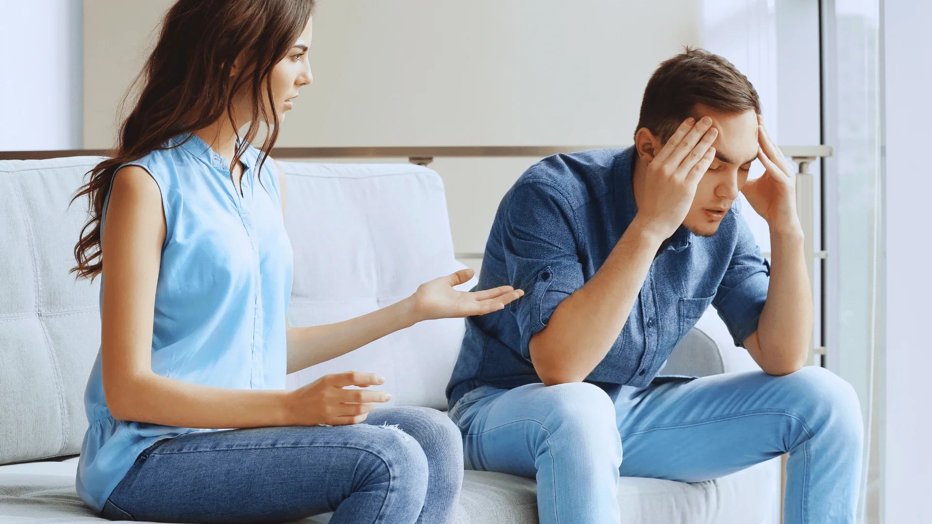 A sad person sitting alone while someone nearby appears emotionally distant, symbolizing hidden feelings and relationship struggles.