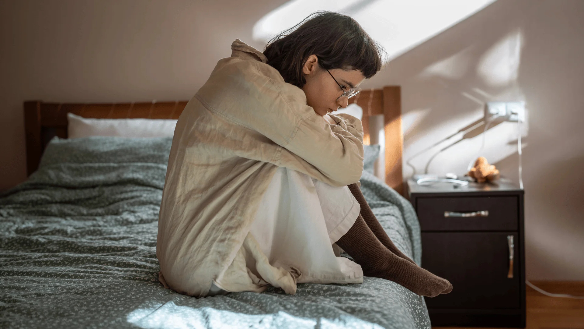 A heartbroken person sitting alone after a breakup while remembering emotional moments from a past relationship.