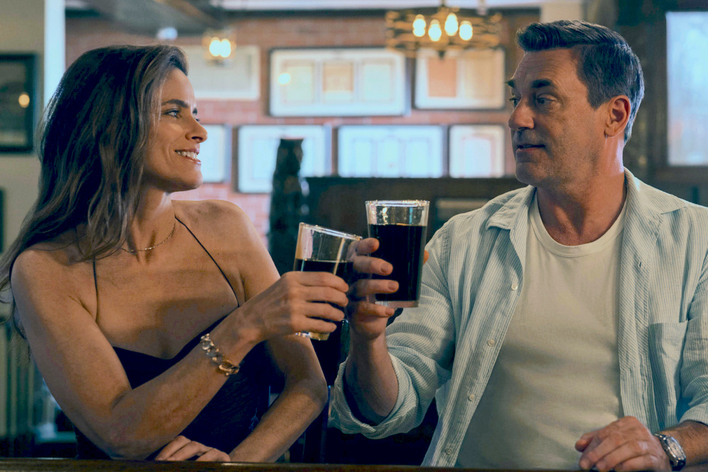 Couple having a thoughtful conversation with zodiac symbols in the background, representing relationship growth and astrology insights.