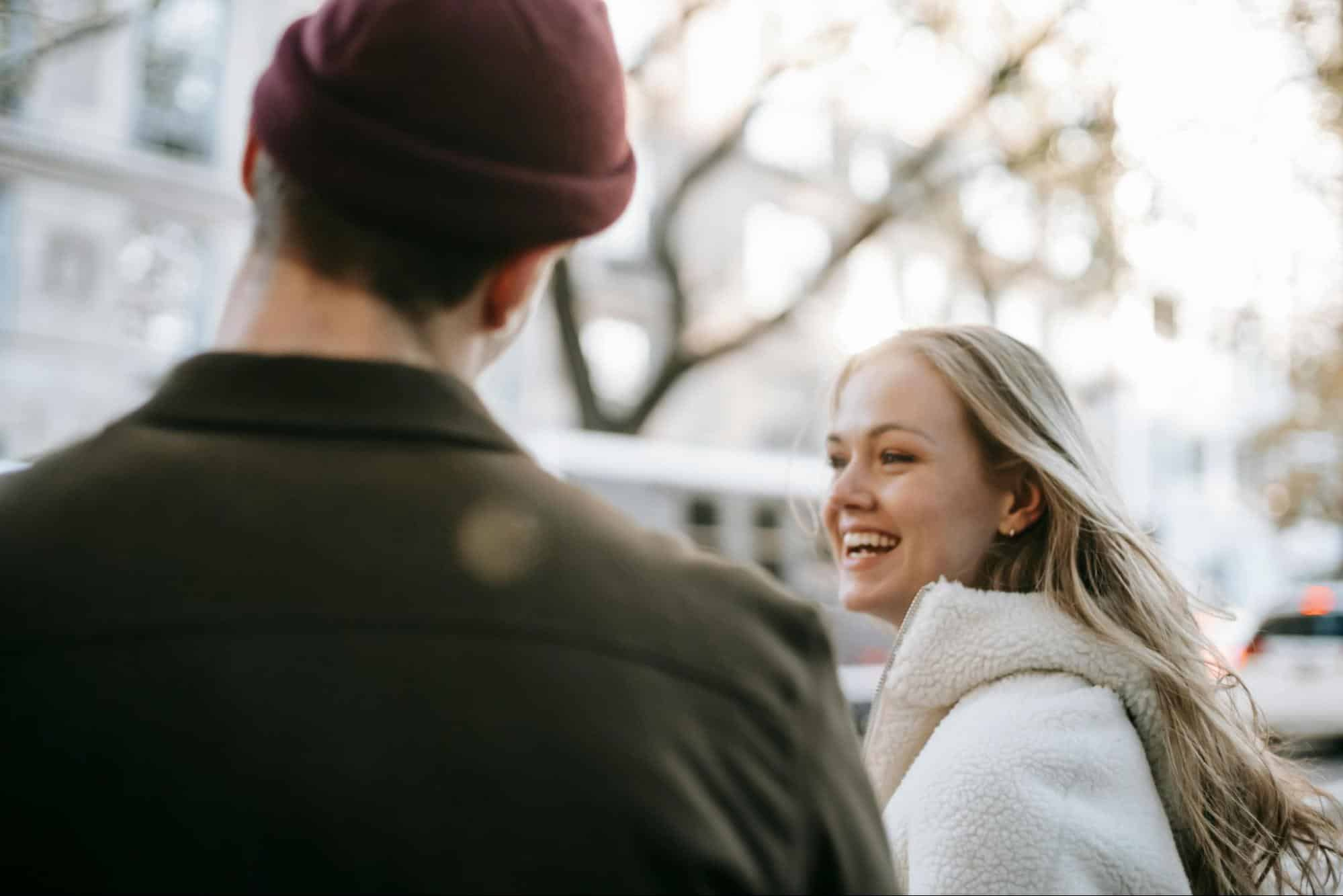 A confident and happy person enjoying life while sharing a warm moment with a loving partner, symbolizing healthy relationships and emotional connection.