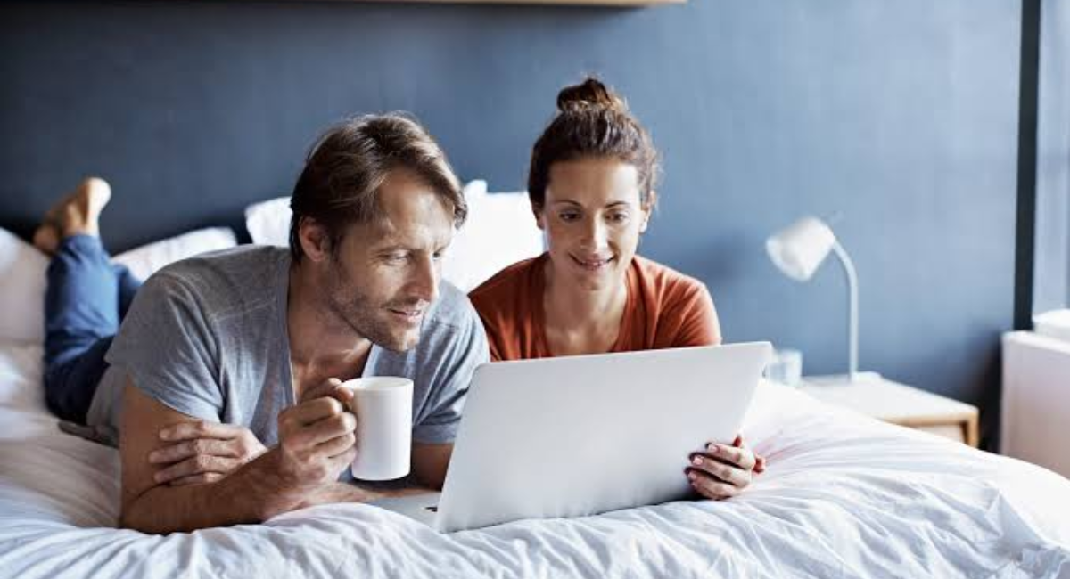A happy couple talking and laughing together while building trust, respect, and emotional connection in their relationship.