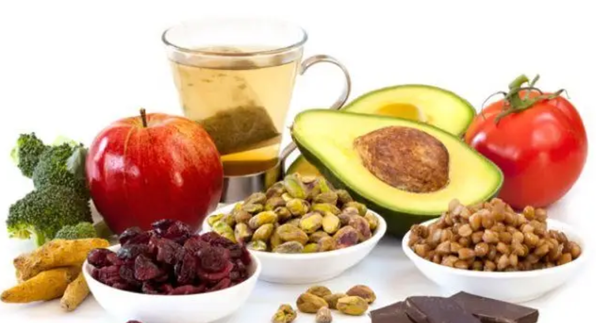 A healthy assortment of iron-rich foods including spinach, lentils, red meat, beans, eggs, pumpkin seeds, beets, and citrus fruits to support healthy hemoglobin levels.