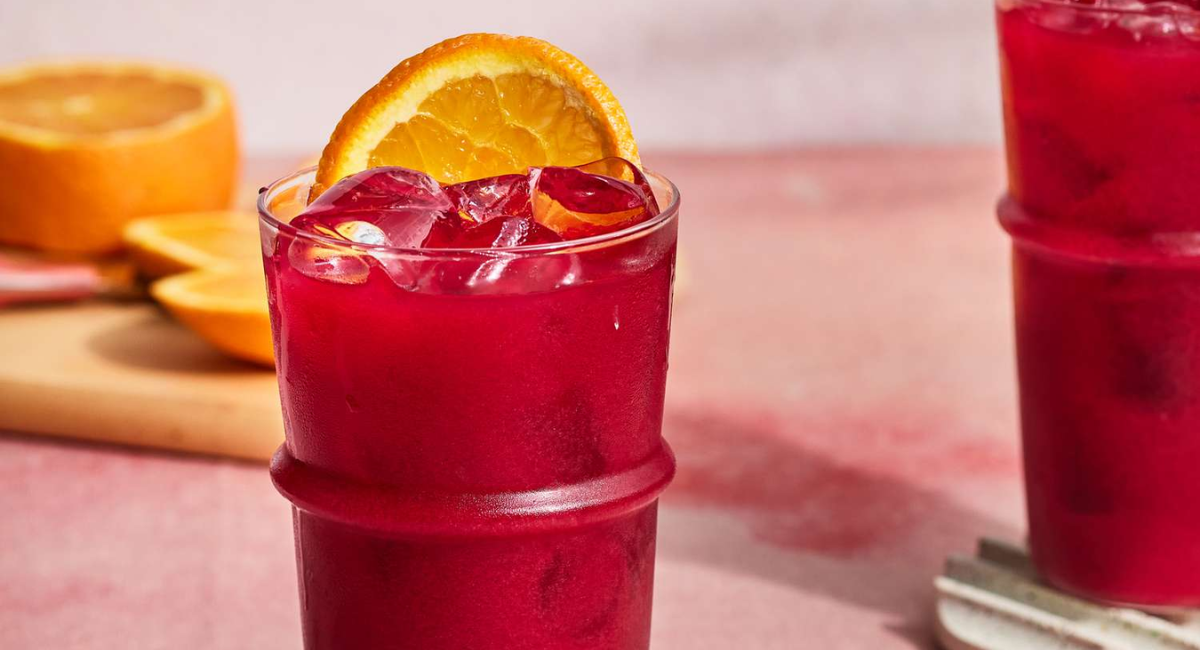 Three homemade red detox juice recipes made with beets, pomegranate, berries, apples, and fresh vegetables served in clear glasses with fresh ingredients.