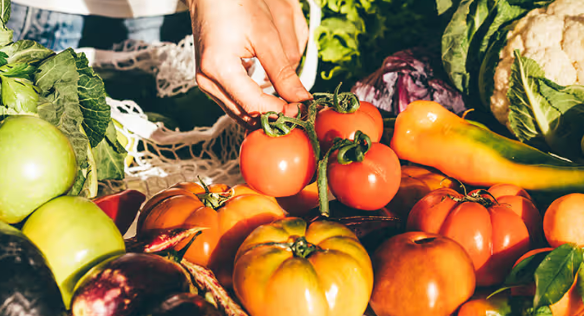 Colorful assortment of healthy foods including fruits, vegetables, nuts, whole grains, fish, and herbs representing the concept of food as medicine.