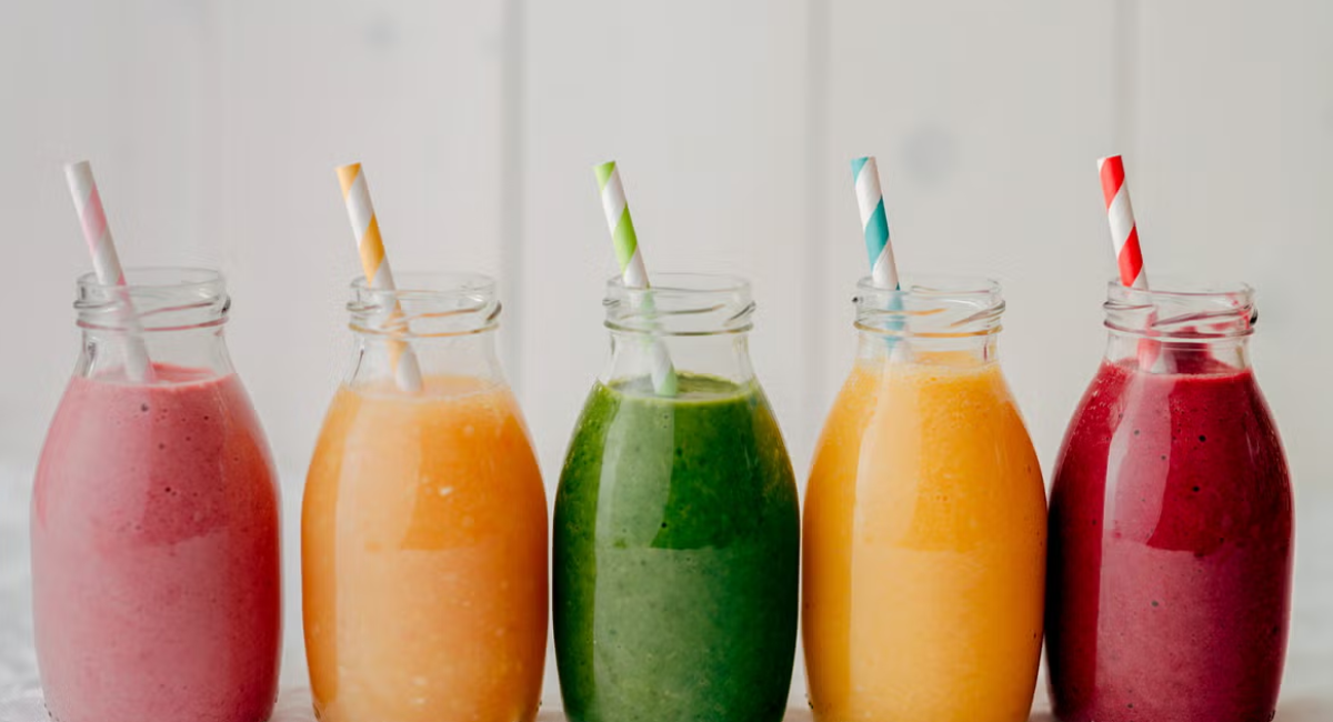 A collection of 10 healthy morning energy juices featuring orange, carrot, beetroot, pineapple, watermelon, cucumber, kiwi, tomato, and pomegranate.
