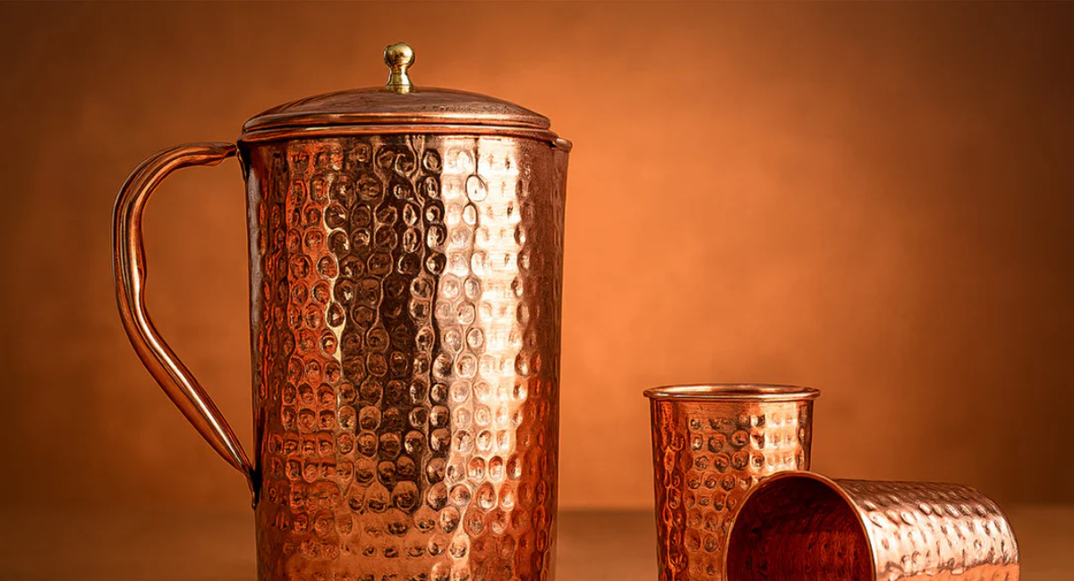 Hammered copper drinking cup filled with water, representing traditional wellness practices and the potential benefits of storing water in copper.