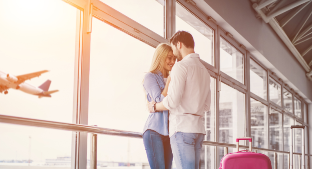 A couple exchanging heartfelt text messages on their smartphones while maintaining a happy long-distance relationship.