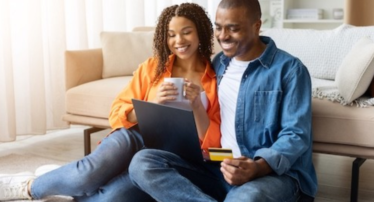 A person reviewing a financial plan with a laptop, calculator, budget spreadsheet, savings account, and investment charts, representing smart financial planning and wealth-building strategies.